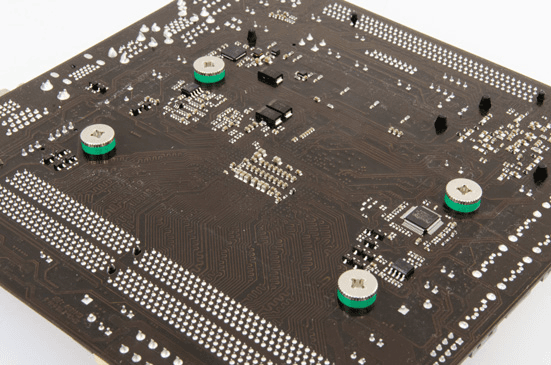 The backside of a motherboard showing installed NM-APS3 spacers.