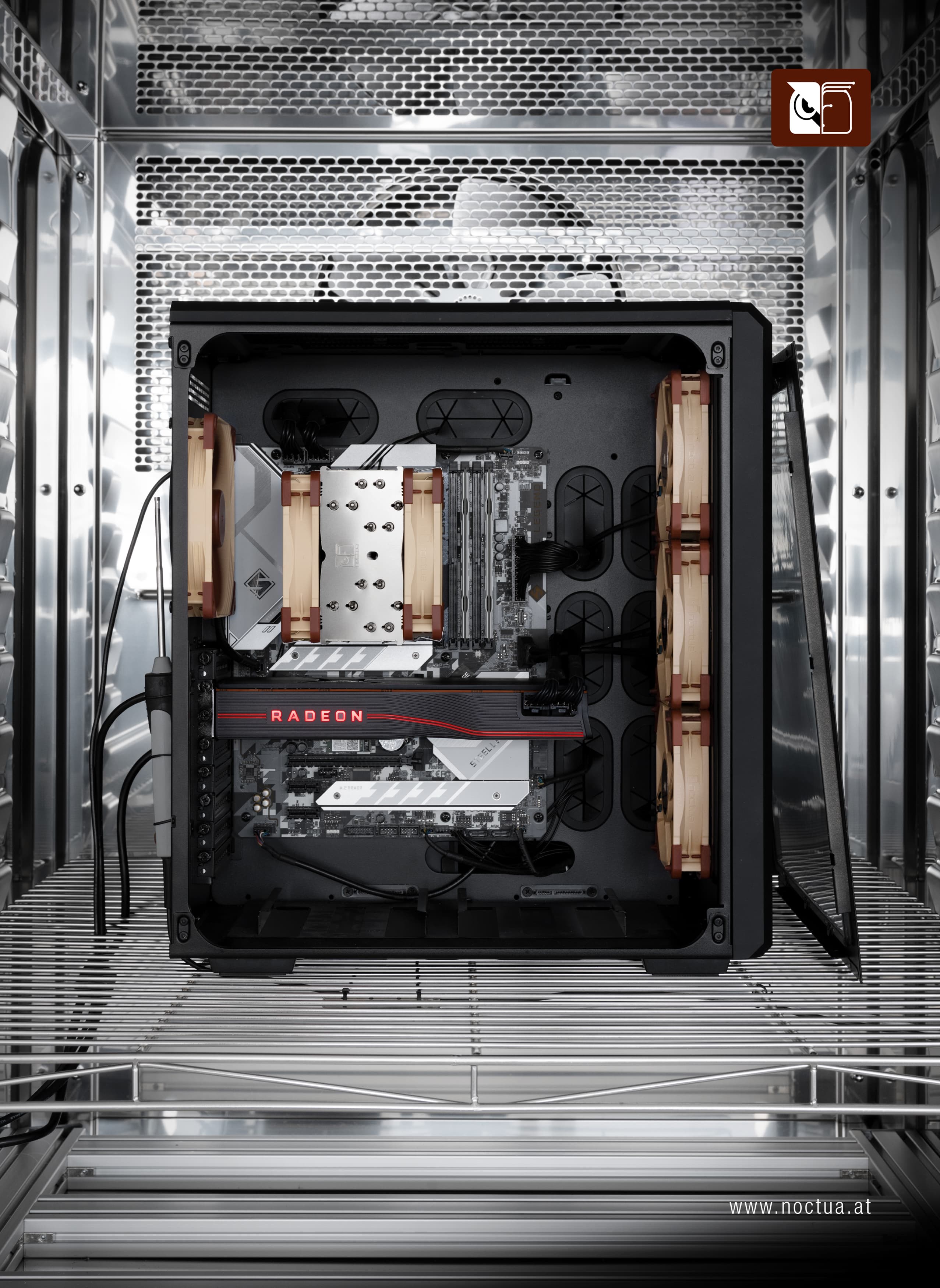 Full view of a PC test setup inside a climate chamber, showcasing Noctua coolers and fans installed for performance testing.
