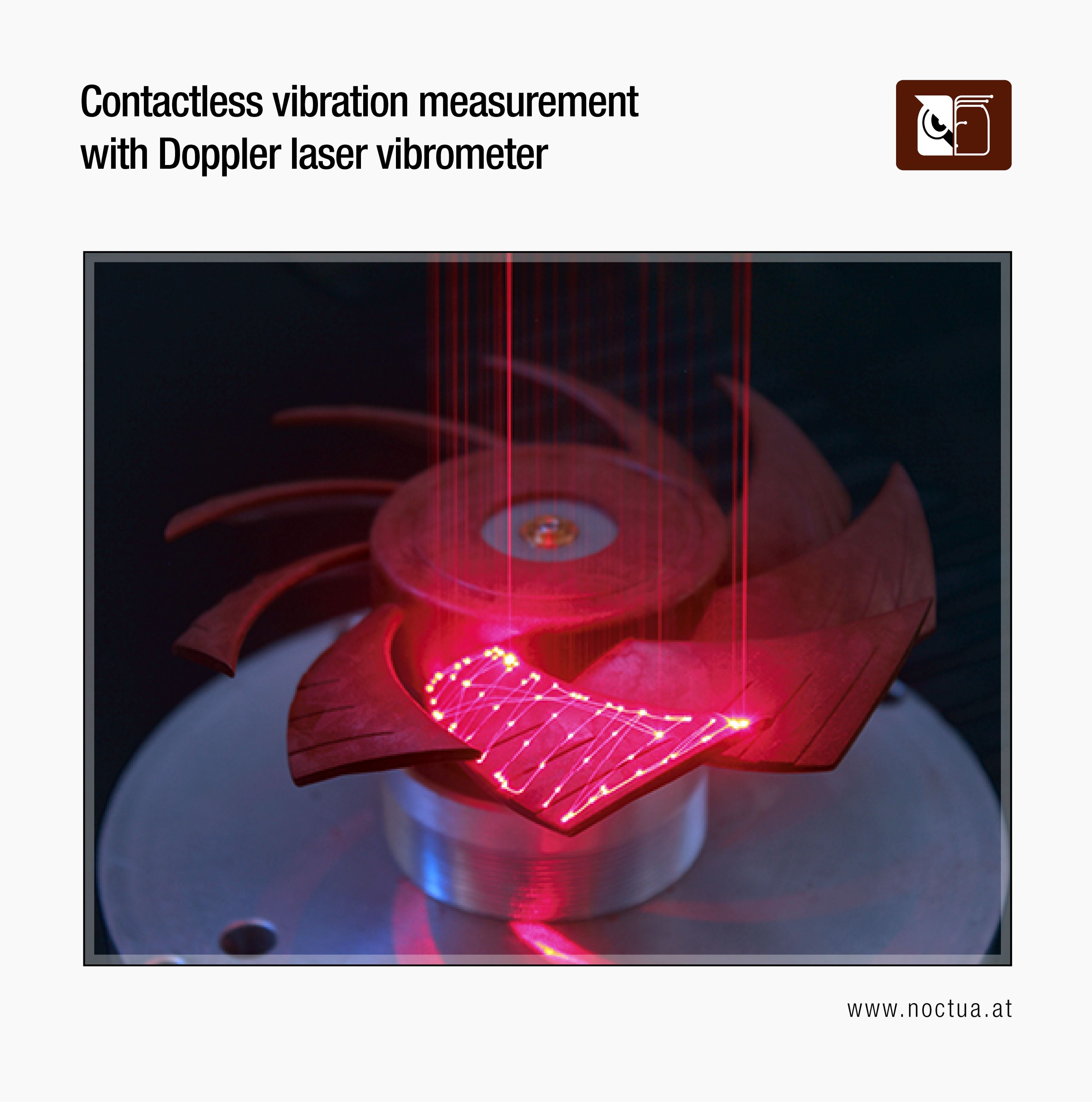A fan blade illuminated with red laser lines for contactless vibration measurement using a Doppler laser vibrometer.