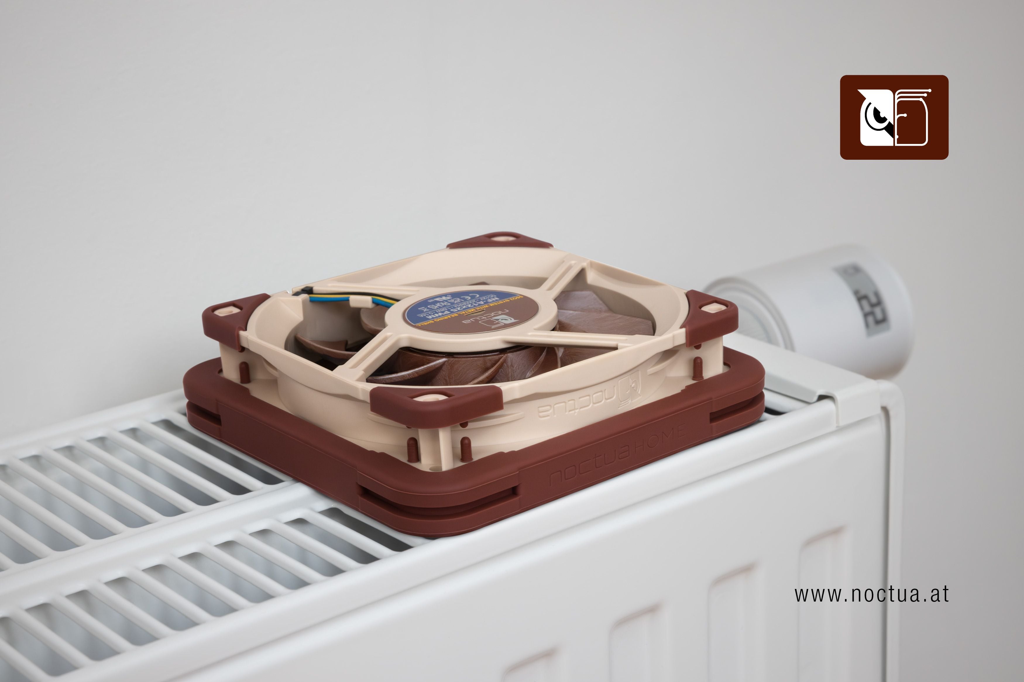 Noctua NF-A12x25 fan equipped with NV-MPG1 gasket placed on a household radiator, demonstrating active radiator ventilation.
