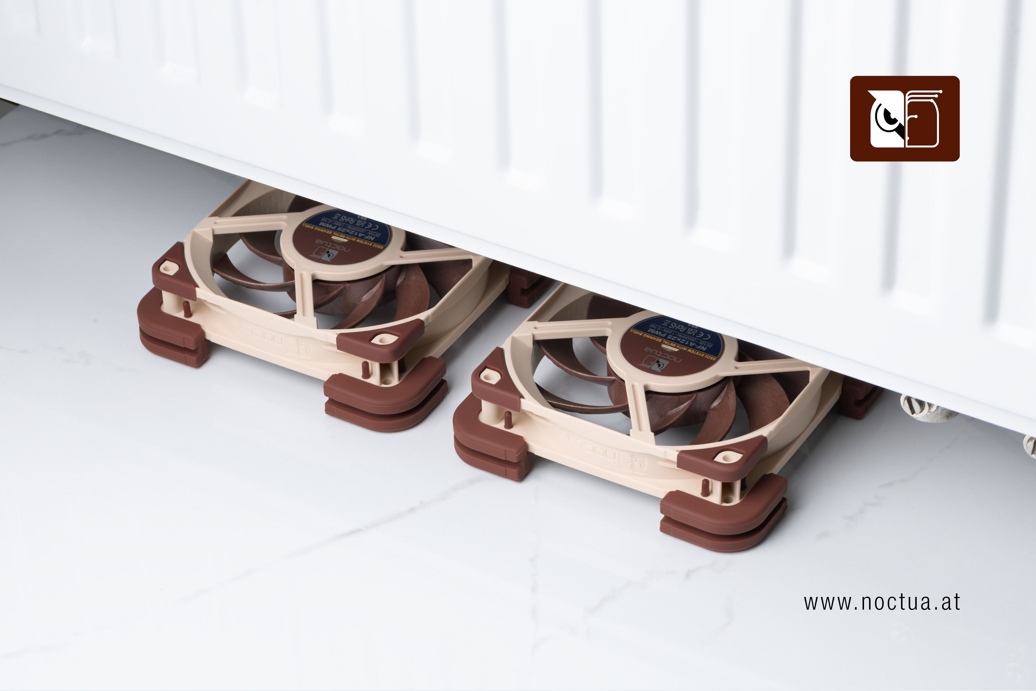 Two Noctua NF-A12x25 fans equipped with NV-MPG1 gaskets and NV-MPP pads placed underneath a household radiator, demonstrating active radiator ventilation.