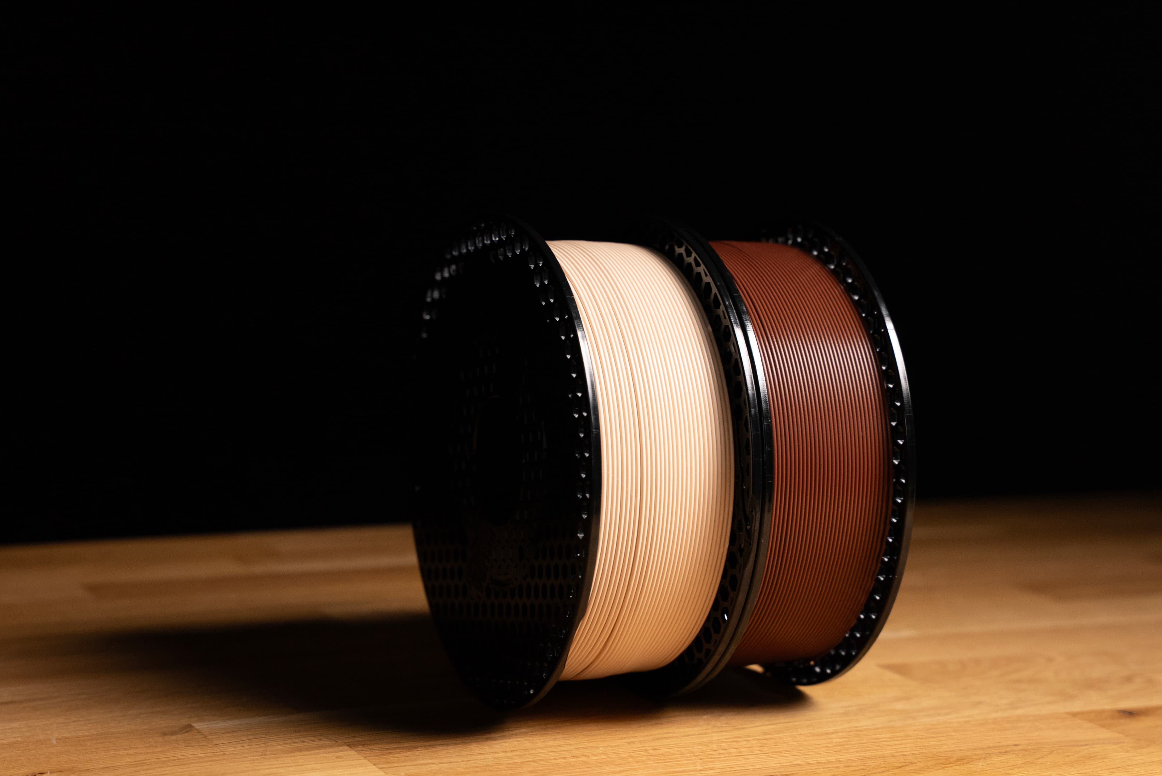 Prusament PLA Noctua Beige and Brown spools on wooden table